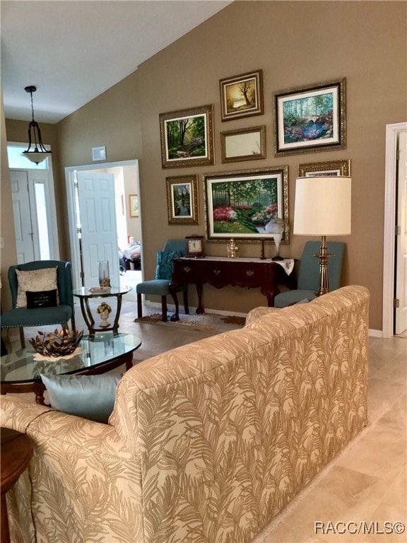 living room featuring light tile patterned floors and vaulted ceiling