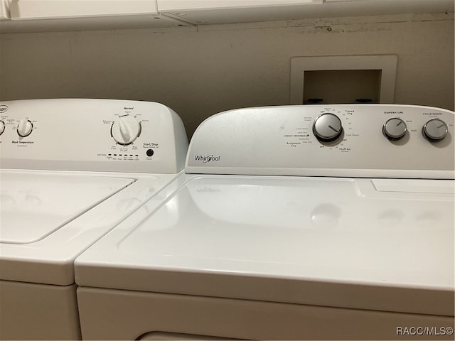 clothes washing area featuring independent washer and dryer