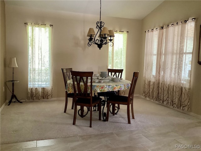 carpeted dining area with a notable chandelier and lofted ceiling