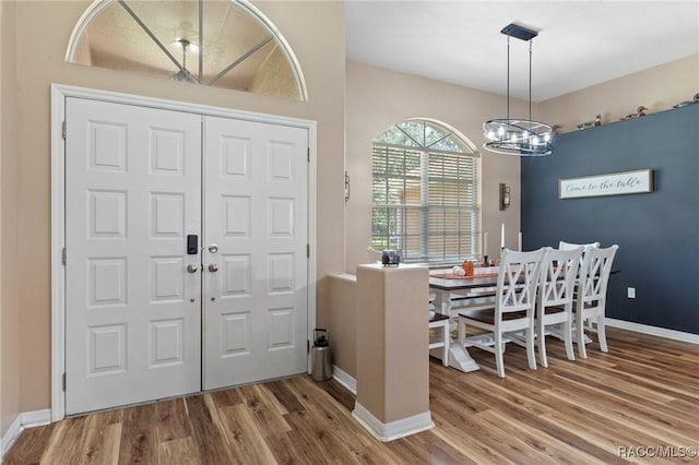 entryway with an inviting chandelier and hardwood / wood-style floors