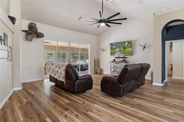 living room featuring wood-type flooring, high vaulted ceiling, and ceiling fan