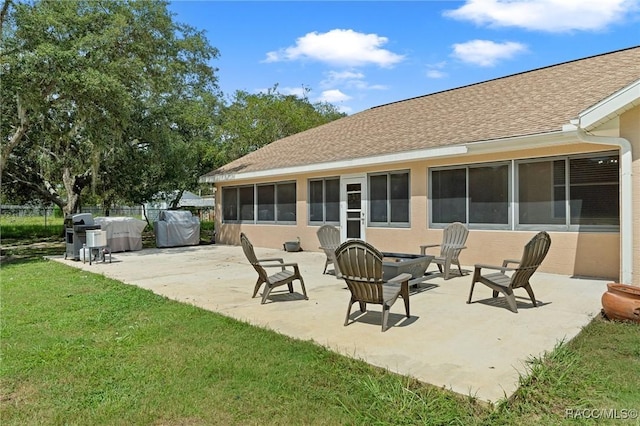 rear view of house with a yard and a patio