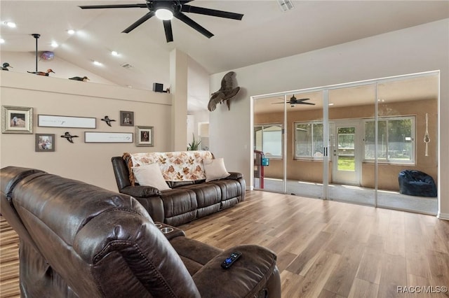 living room featuring lofted ceiling, light hardwood / wood-style flooring, and ceiling fan