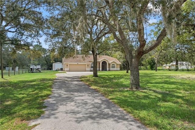 view of front of property with a garage and a front lawn