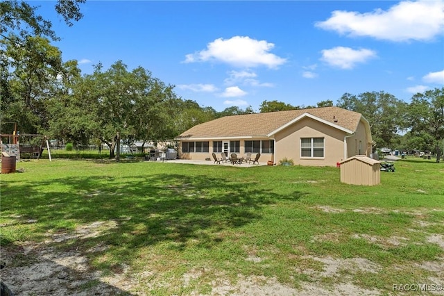 back of property with a patio and a yard