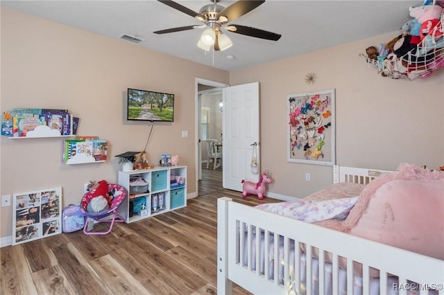 bedroom featuring wood-type flooring and ceiling fan