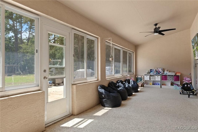 sunroom featuring ceiling fan, plenty of natural light, and vaulted ceiling