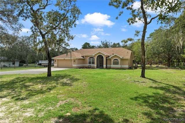 ranch-style home featuring a garage and a front yard