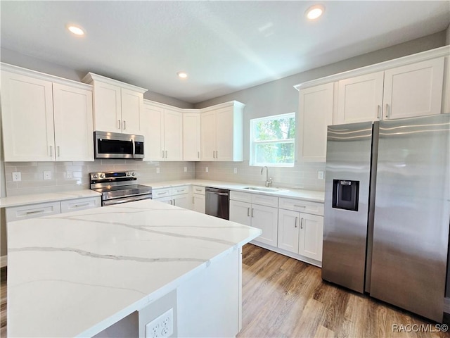 8 Calendula Ct, Homosassa, FL 34446 - kitchen featuring stainless steel appliances, a sink, a center island, white cabinetry, and recessed lighting