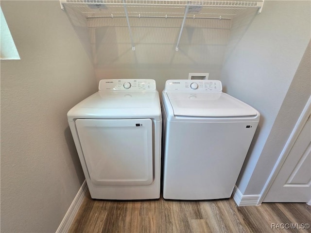 8 Calendula Ct, Homosassa, FL 34446 - laundry area featuring wood finished floors, independent washer and dryer, and baseboards