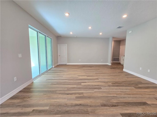 8 Calendula Ct, Homosassa, FL 34446 - spare room with recessed lighting, baseboards, and wood finished floors