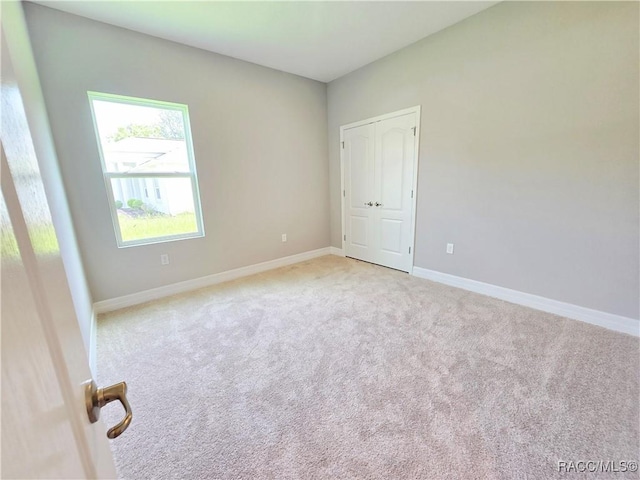 8 Calendula Ct, Homosassa, FL 34446 - spare room featuring light colored carpet and baseboards