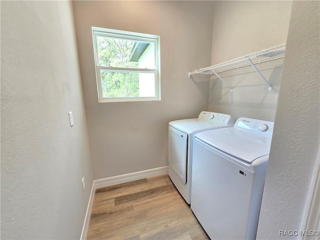 8 Calendula Ct, Homosassa, FL 34446 - washroom with washing machine and dryer, light wood-type flooring, and baseboards