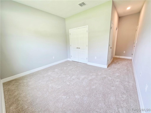 8 Calendula Ct, Homosassa, FL 34446 - unfurnished bedroom with light carpet, baseboards, and a closet
