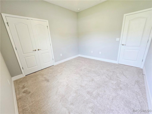 8 Calendula Ct, Homosassa, FL 34446 - unfurnished bedroom with carpet flooring, baseboards, and a closet