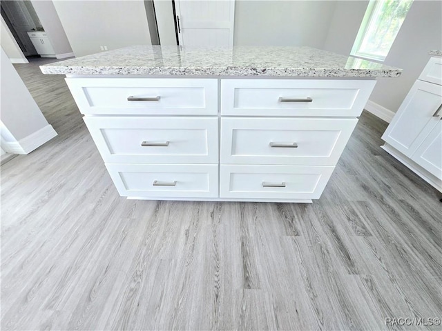 interior details with baseboards and wood finished floors