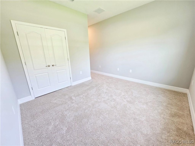 8 Calendula Ct, Homosassa, FL 34446 - unfurnished bedroom featuring a closet, carpet flooring, and baseboards