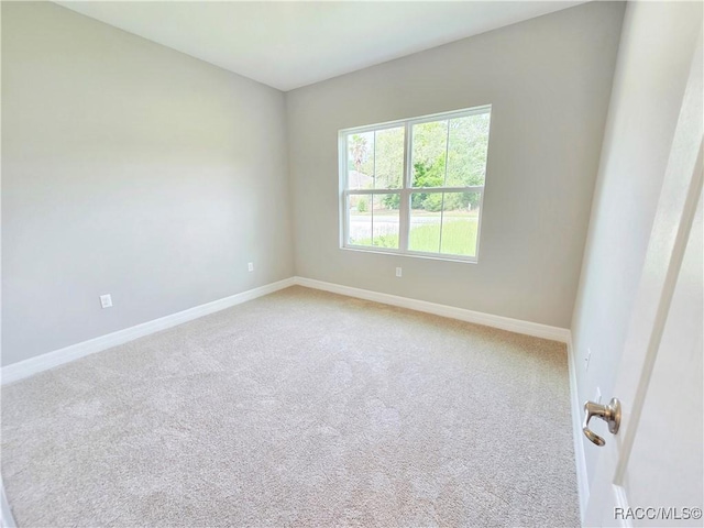 8 Calendula Ct, Homosassa, FL 34446 - empty room featuring baseboards and light colored carpet