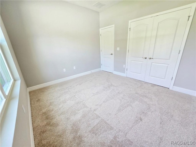 8 Calendula Ct, Homosassa, FL 34446 - unfurnished bedroom with carpet floors, a closet, and baseboards