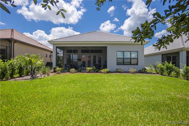 back of property featuring a yard, ceiling fan, and a sunroom