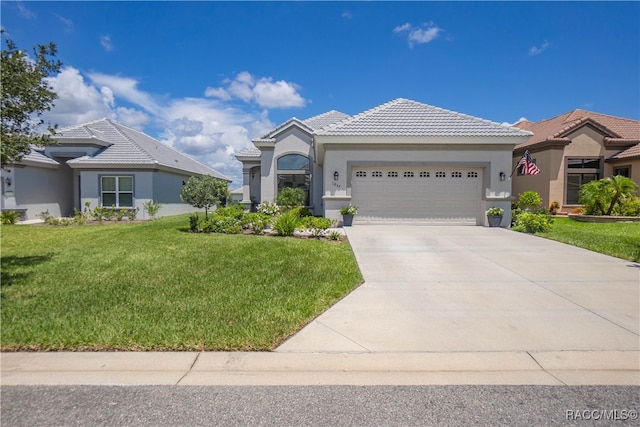 view of front of house with a front yard and a garage