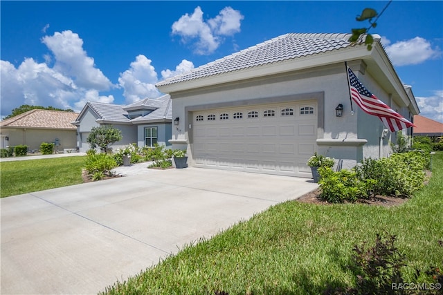 view of front of house featuring a garage and a front lawn