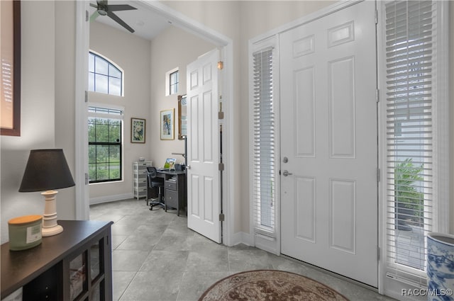 tiled entryway with ceiling fan