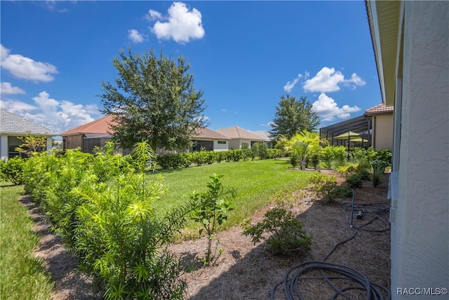 view of yard with glass enclosure