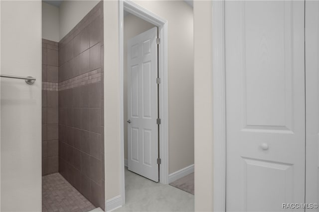 bathroom with a tile shower