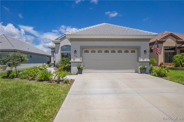 view of front facade with a garage and a front lawn