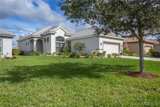 view of front of house with a front yard and a garage