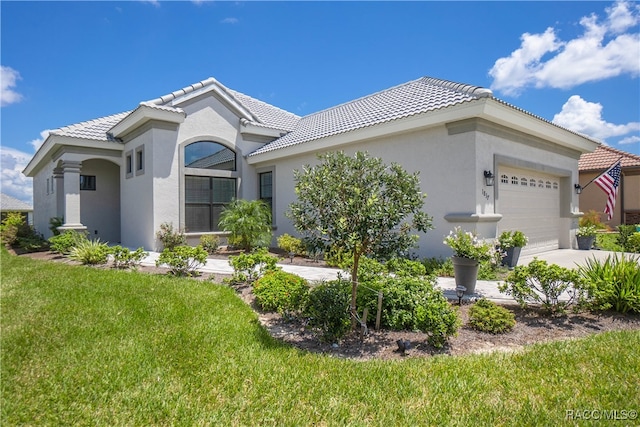 view of front of house with a front yard and a garage