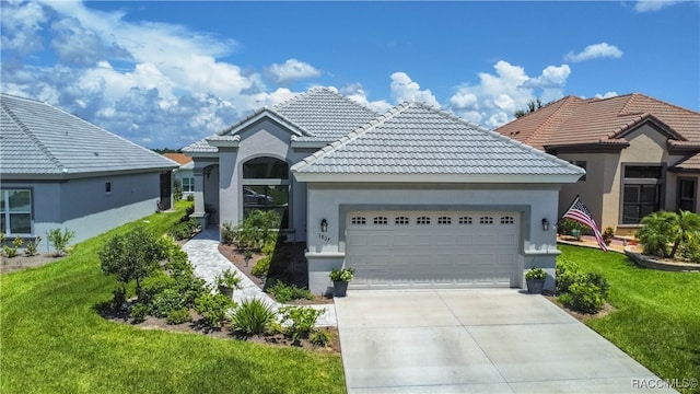 view of front of property featuring a garage and a front yard