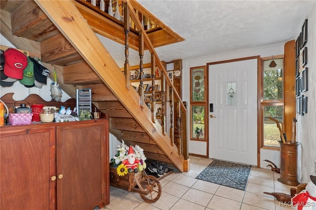 tiled foyer with a textured ceiling and a wealth of natural light