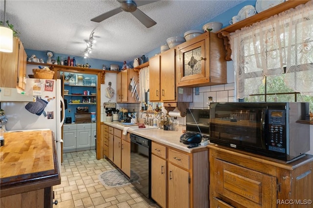 kitchen with backsplash, track lighting, black appliances, sink, and a textured ceiling