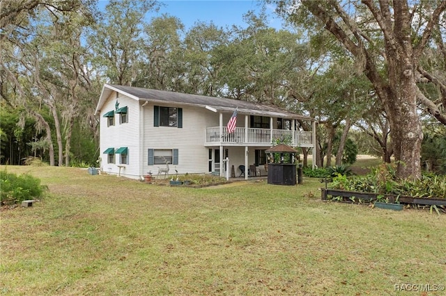 rear view of property featuring a yard