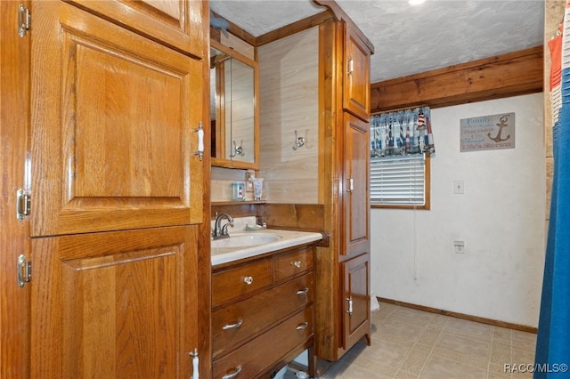 bathroom with a textured ceiling and vanity