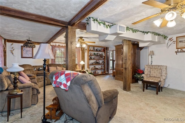 carpeted living room with beam ceiling and a textured ceiling