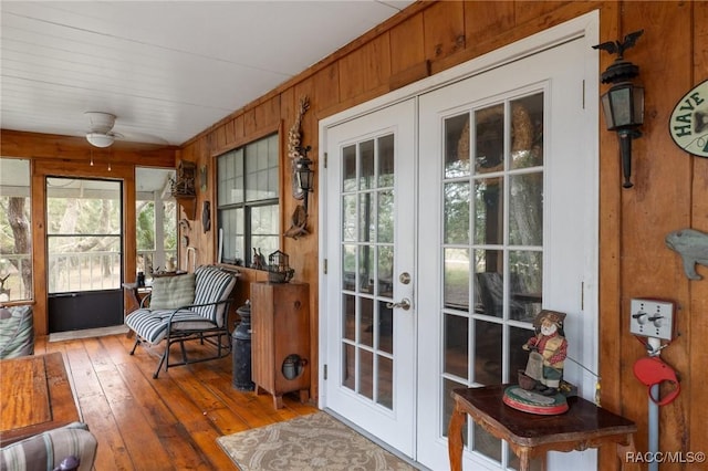 sunroom / solarium featuring ceiling fan and french doors