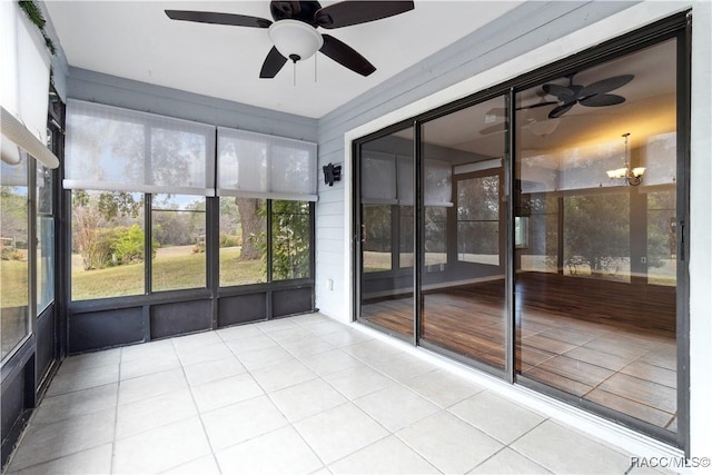 unfurnished sunroom with ceiling fan