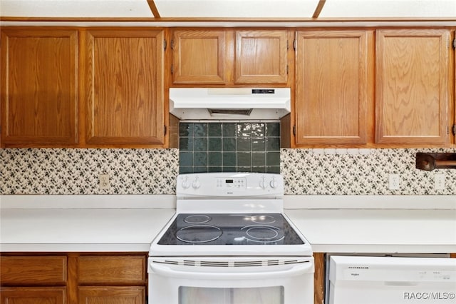 kitchen with backsplash and white appliances