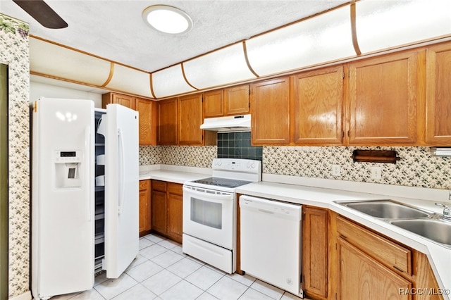 kitchen with tasteful backsplash, sink, white appliances, and light tile patterned flooring