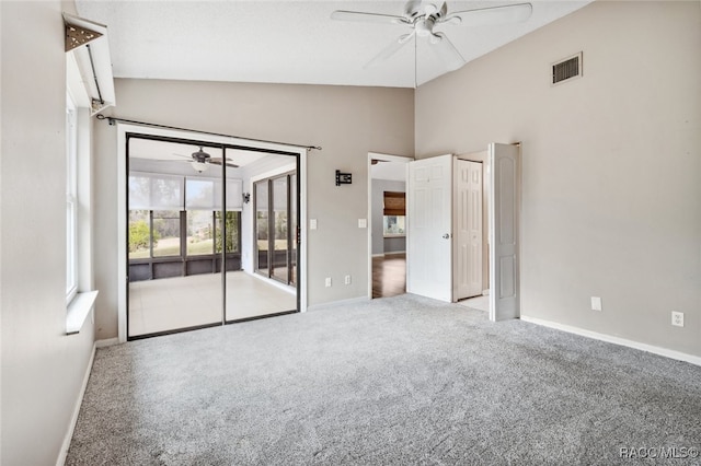 unfurnished room featuring ceiling fan, carpet flooring, and vaulted ceiling