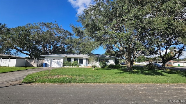 single story home with a garage and a front lawn