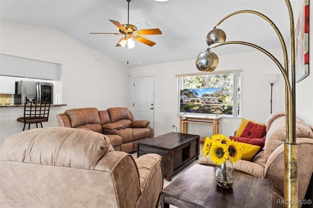 living room featuring ceiling fan and lofted ceiling