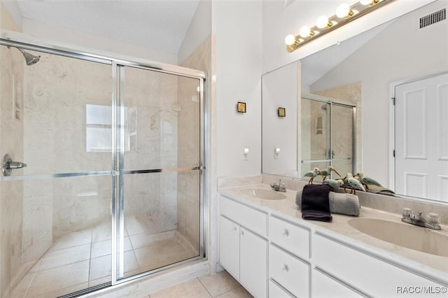 bathroom with lofted ceiling, tile patterned floors, an enclosed shower, and vanity