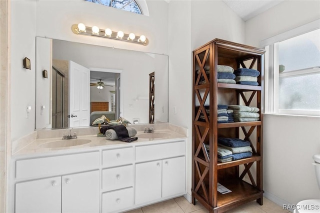 bathroom with a shower with shower door, vanity, ceiling fan, and tile patterned flooring