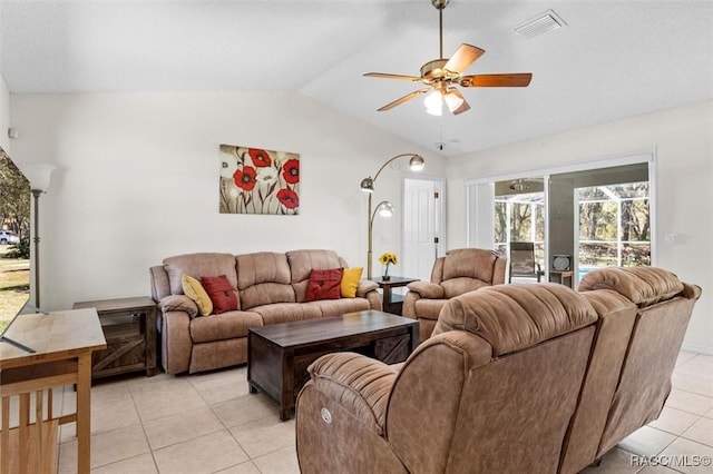 living room with ceiling fan, light tile patterned floors, and vaulted ceiling