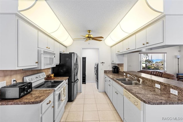 kitchen featuring white appliances, white cabinets, a textured ceiling, sink, and ceiling fan