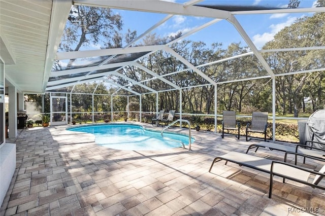 view of pool with a lanai and a patio